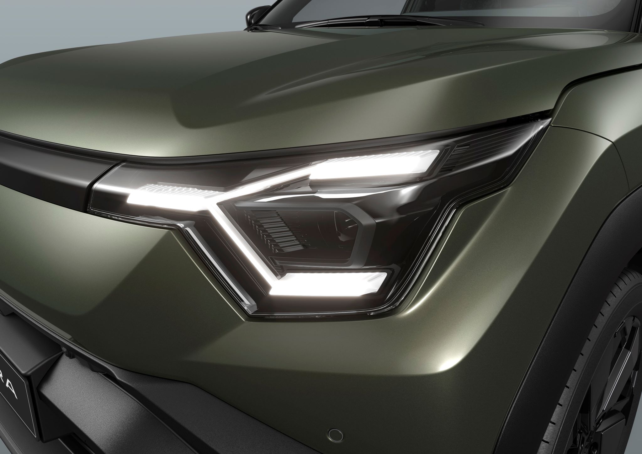 Close-up of a modern car's sleek front headlight design, featuring LED lights.
