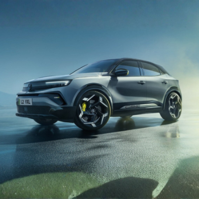 Futuristic silver SUV parked, side view with distinctive alloy wheels.