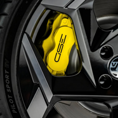 Close-up of a car wheel featuring a yellow brake caliper.