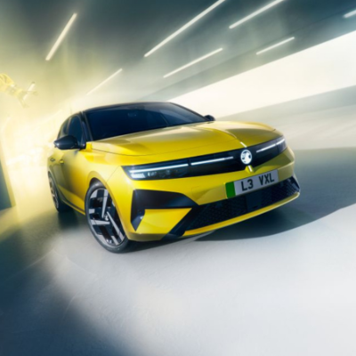 Yellow car with black accents and futuristic design in well-lit setting.