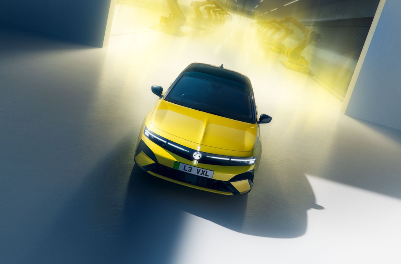 Yellow car in a brightly lit indoor space.