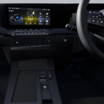Car interior showing a digital dashboard and steering wheel.