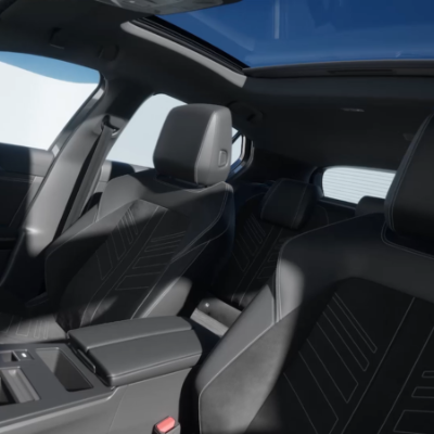 Interior of a car with black leather seats and a panoramic sunroof.